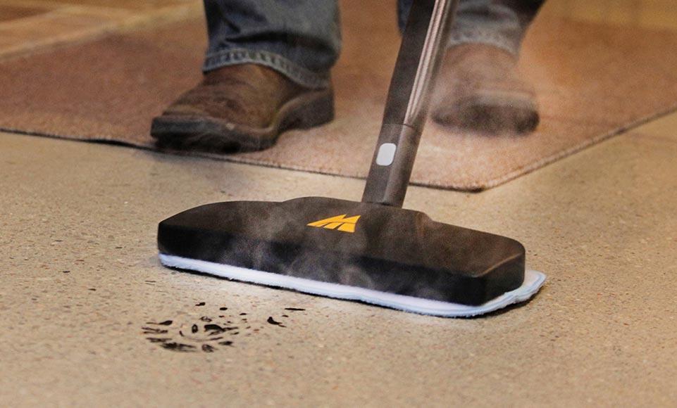 MC1275 Clean Anything Man using MC1275 Canister Steam Cleaner's mop to clean up muddy footprints