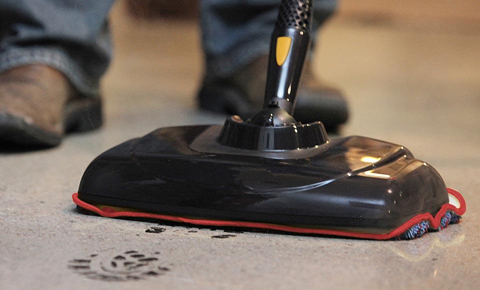 MC Clean Anything Man using a McCulloch mop to clean up muddy footprints